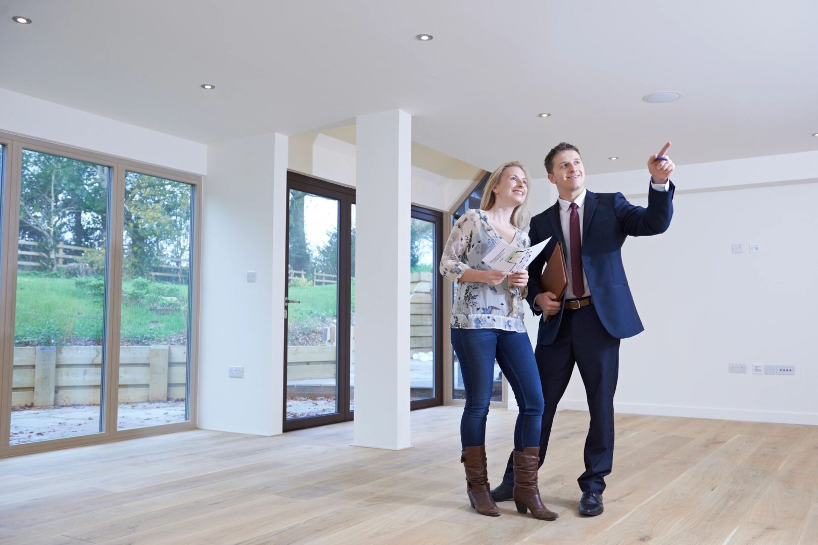 A man and woman looking at something in the room.